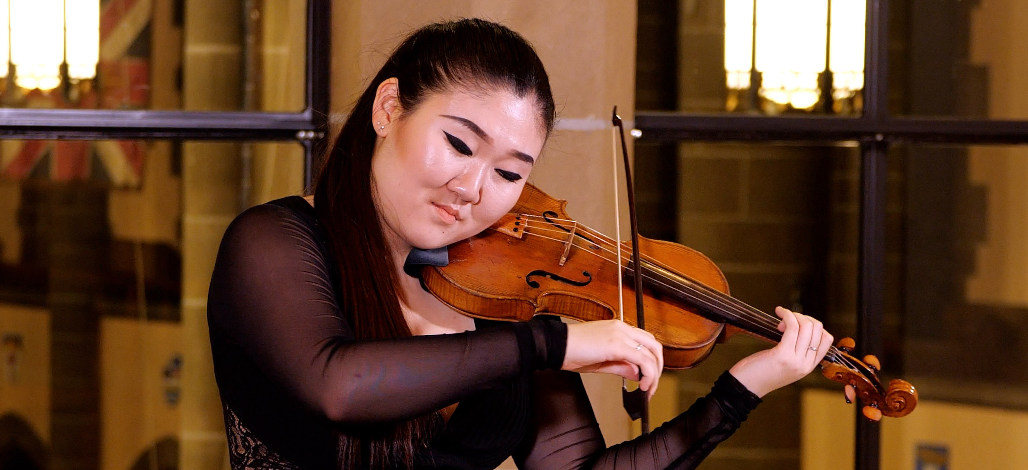 Chloe Kim, participating artist in Emergin Artist Program, playing violin