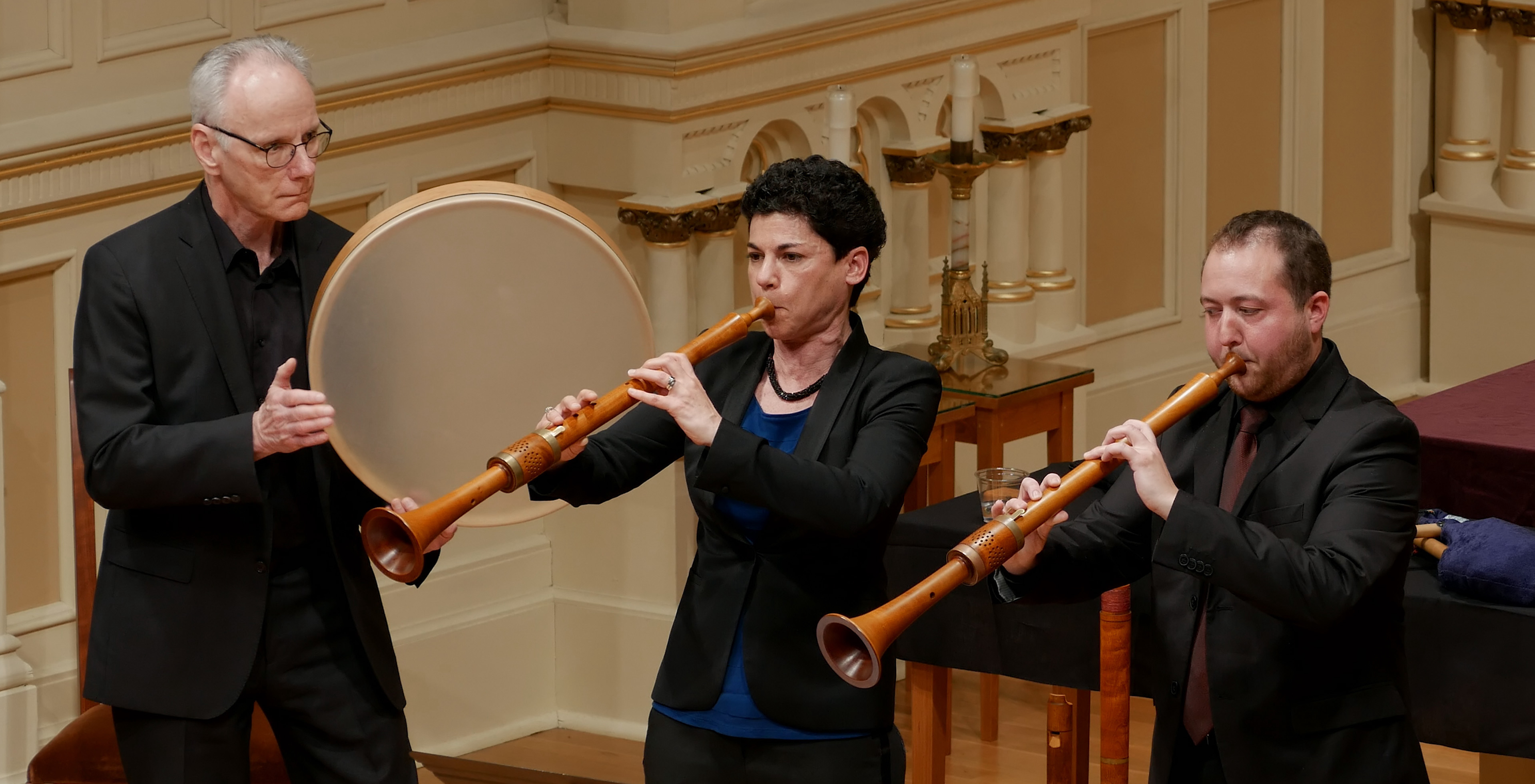 three musicians playing in concert